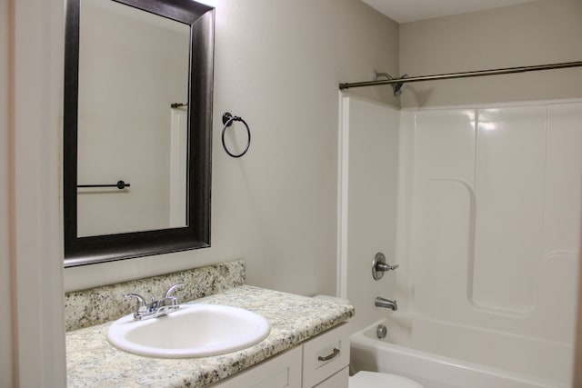 full bathroom with vanity, shower / bath combination, and toilet