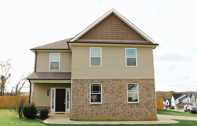 back of house with a lawn