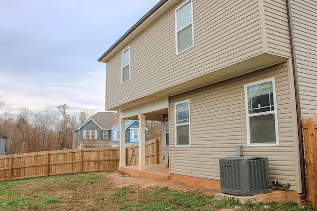 back of house with central AC