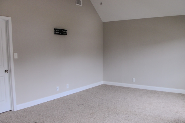 unfurnished room with carpet and lofted ceiling