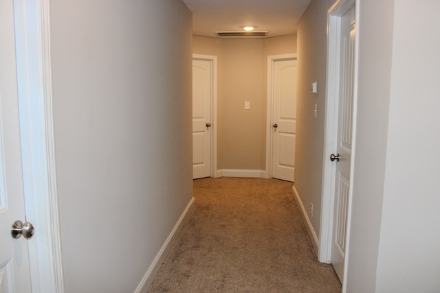 hallway with light colored carpet