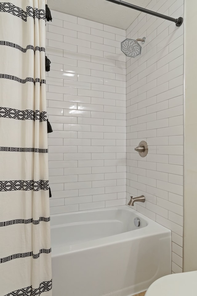 bathroom with shower / bath combo with shower curtain and toilet