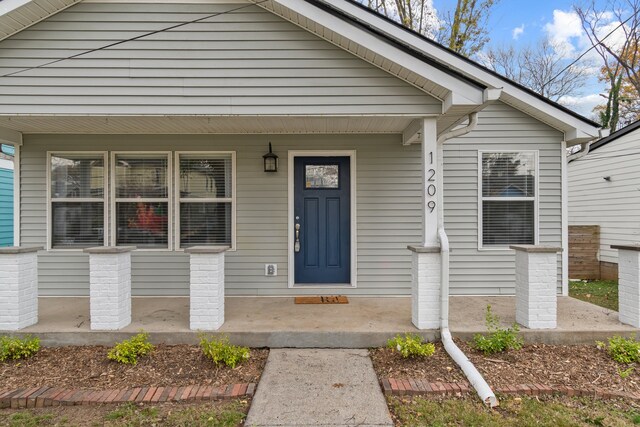 view of exterior entry with covered porch