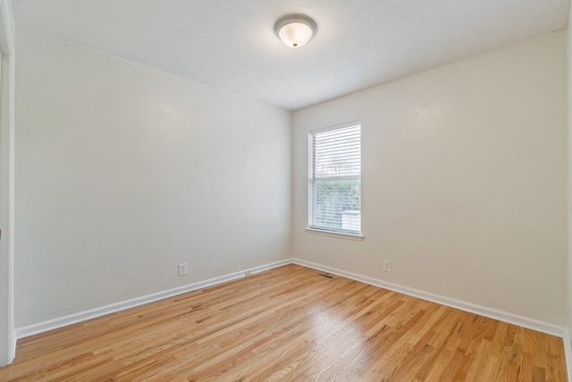 unfurnished room with light hardwood / wood-style flooring