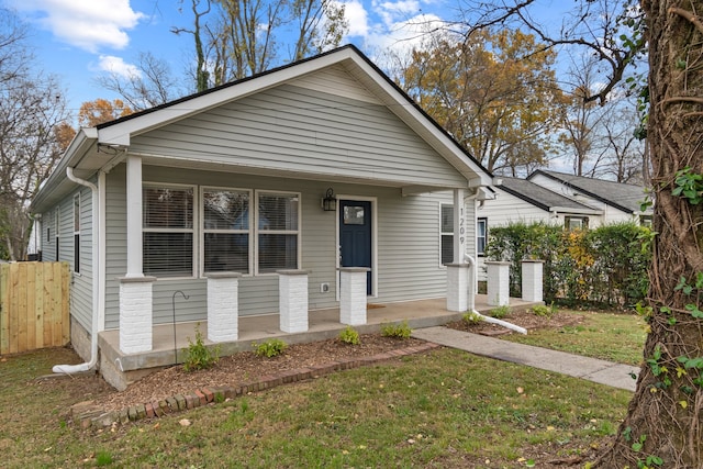 bungalow-style house featuring a front lawn and covered porch