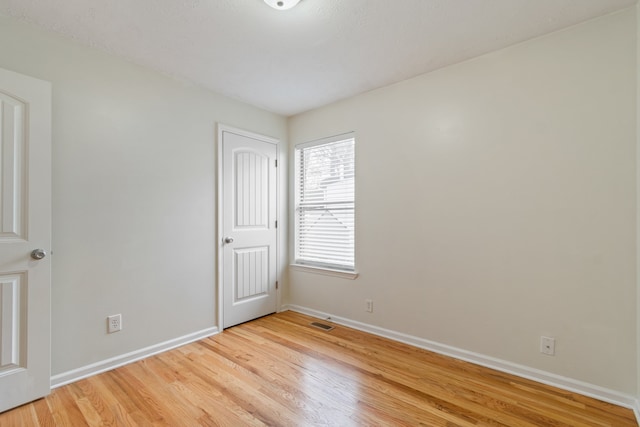 unfurnished room featuring light hardwood / wood-style floors