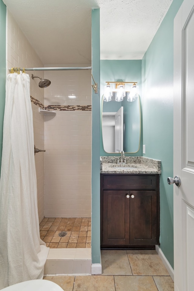 bathroom featuring a shower with curtain, tile patterned flooring, a textured ceiling, toilet, and vanity