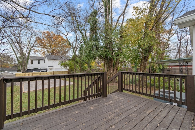 wooden terrace featuring a yard