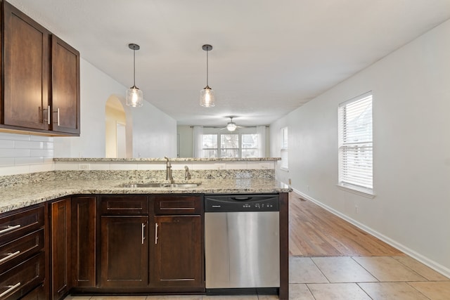 kitchen with light hardwood / wood-style floors, plenty of natural light, stainless steel dishwasher, and sink