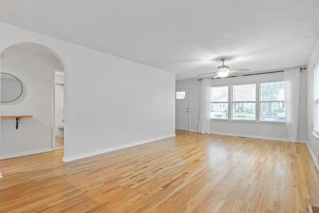 unfurnished living room featuring ceiling fan and light wood-type flooring