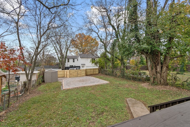 view of yard featuring a patio and a storage shed