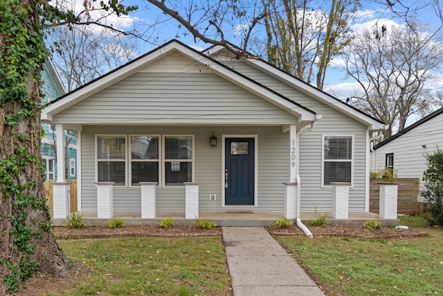 bungalow-style home featuring a porch and a front lawn