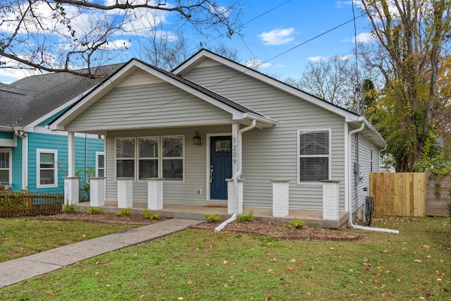 bungalow with a front lawn and covered porch