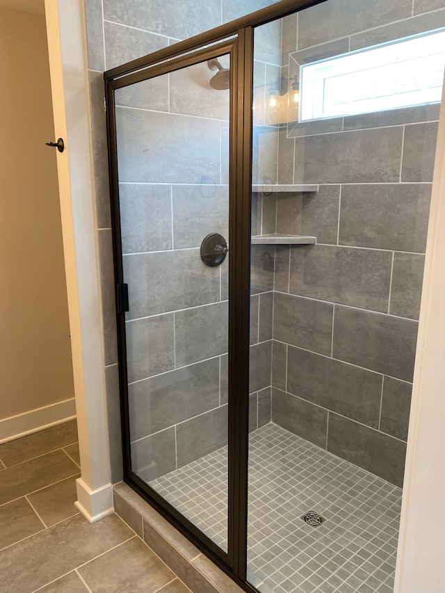 bathroom featuring tile patterned floors and an enclosed shower