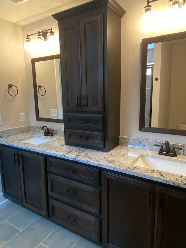 bathroom featuring tile patterned flooring and vanity