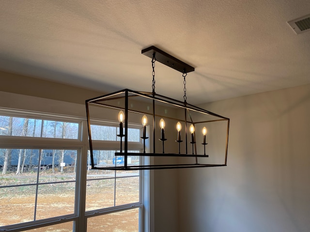 room details with a textured ceiling and an inviting chandelier