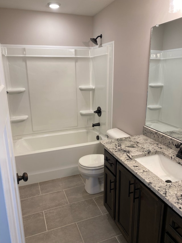 full bathroom with bathtub / shower combination, tile patterned floors, vanity, and toilet