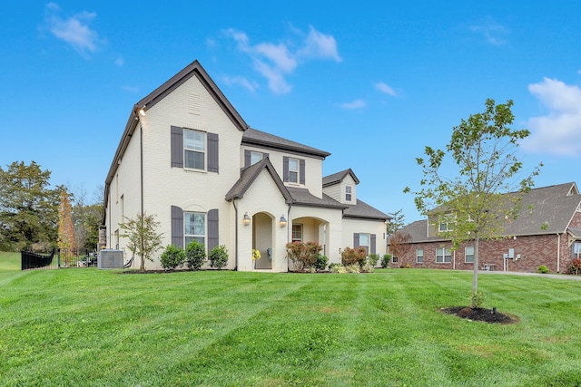 view of front of home featuring central AC unit and a front lawn