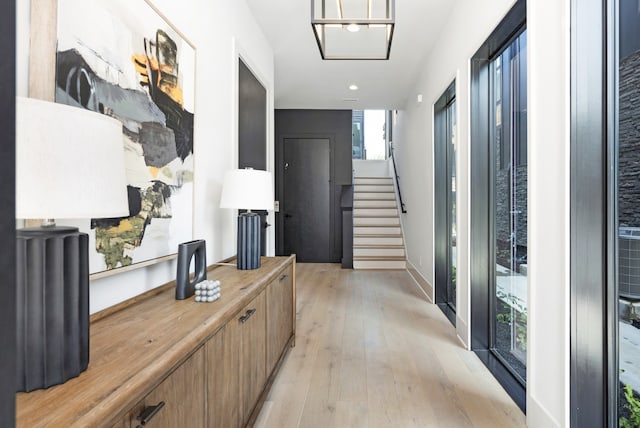 hallway with light hardwood / wood-style flooring