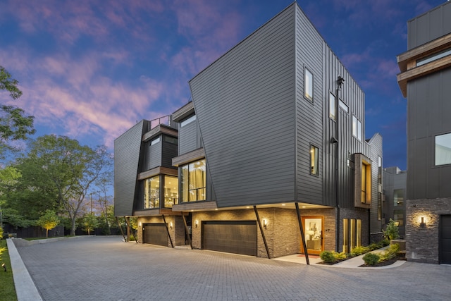 property exterior at dusk with a garage