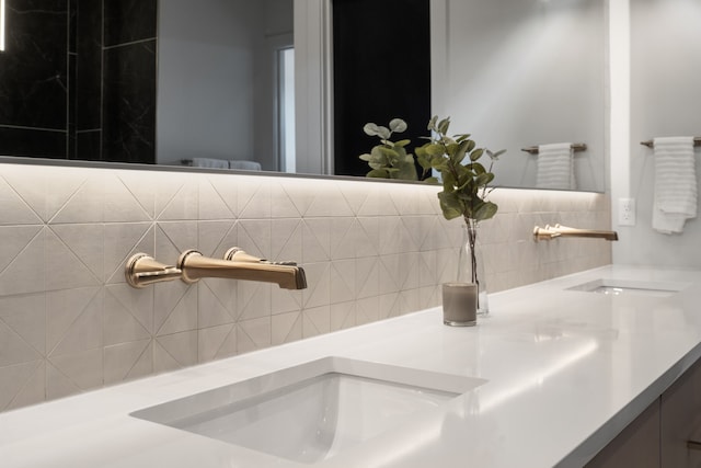 bathroom with decorative backsplash and vanity