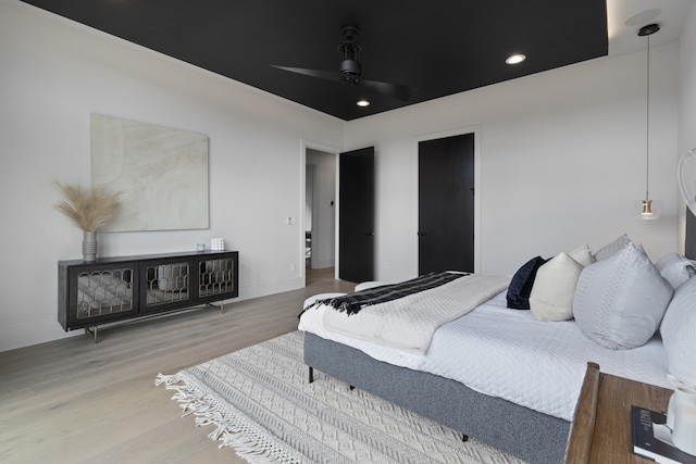 bedroom with hardwood / wood-style flooring and ceiling fan