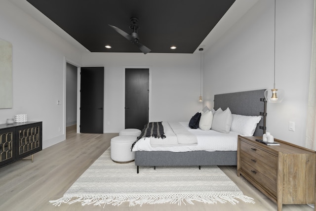 bedroom with ceiling fan and light wood-type flooring