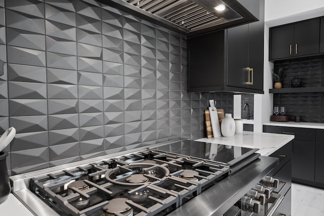 kitchen featuring stainless steel stovetop and tasteful backsplash