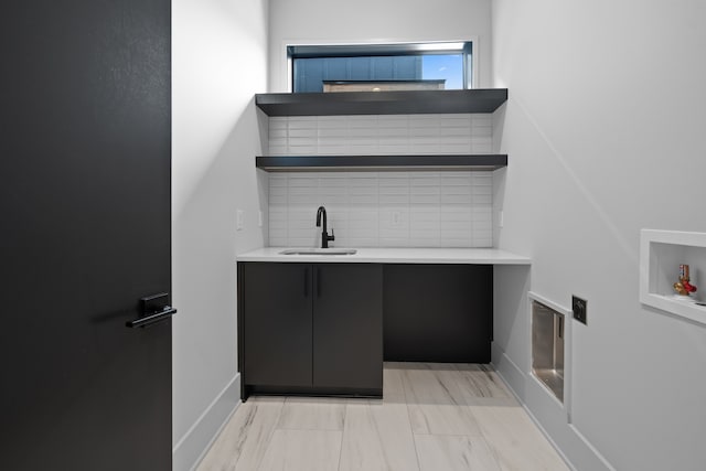 laundry area with cabinets, washer hookup, and sink