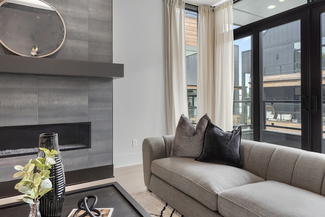 living room with a tile fireplace