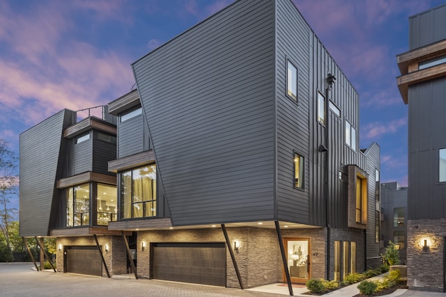 property exterior at dusk featuring a garage