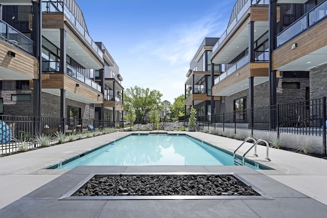 view of swimming pool featuring an outdoor fire pit