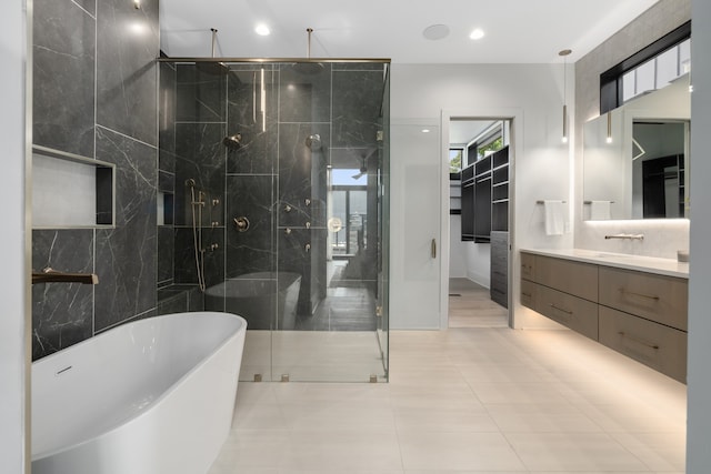 bathroom featuring tile patterned floors, vanity, and separate shower and tub