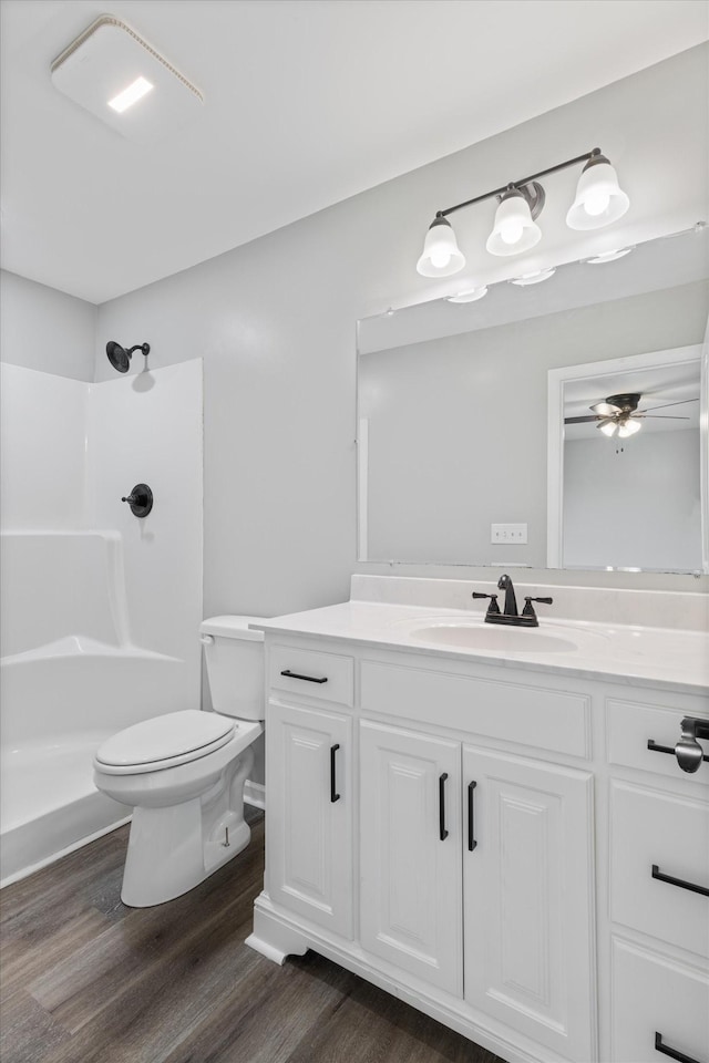 bathroom with ceiling fan, a shower, wood-type flooring, and vanity