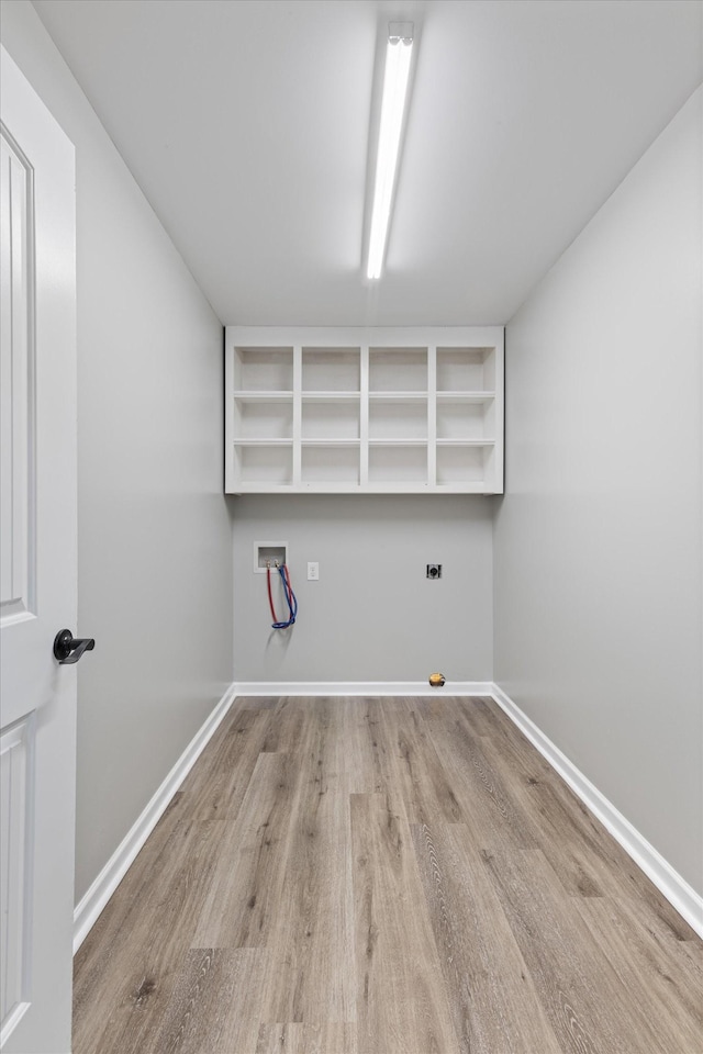 washroom with light wood-type flooring and hookup for a washing machine