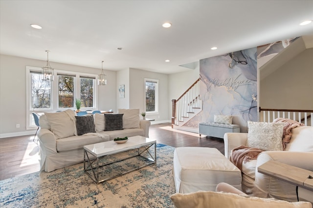 living room with wood-type flooring and a chandelier