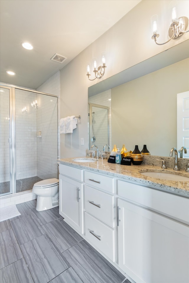 bathroom with vanity, toilet, and walk in shower