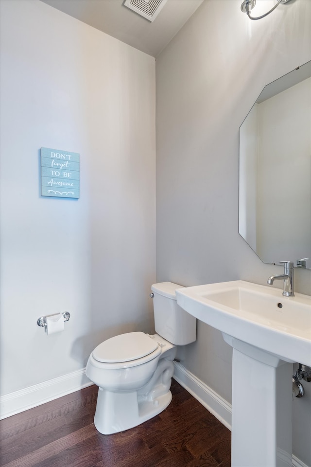 bathroom featuring toilet and hardwood / wood-style flooring