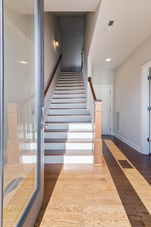 stairs with hardwood / wood-style floors