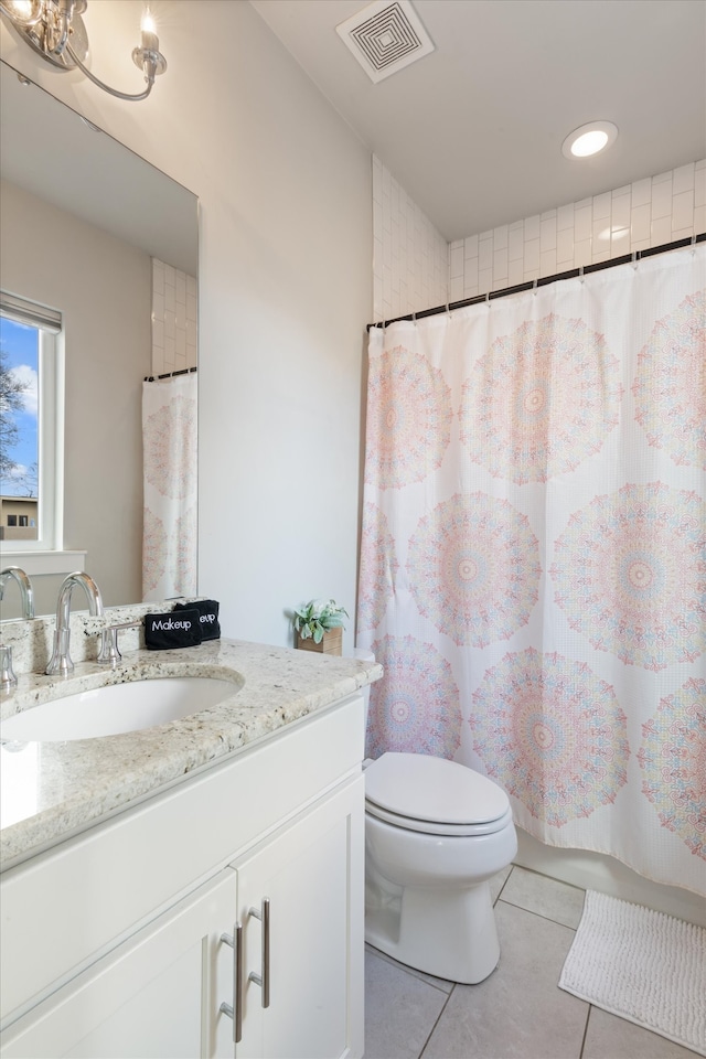 bathroom featuring walk in shower, tile patterned flooring, vanity, and toilet