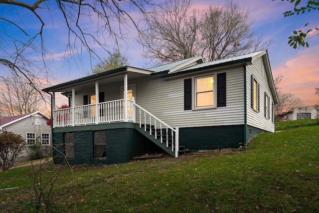 view of front of house with a yard and covered porch