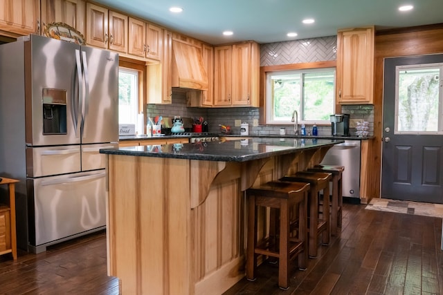 kitchen with stainless steel appliances, dark hardwood / wood-style flooring, backsplash, a kitchen island, and custom range hood