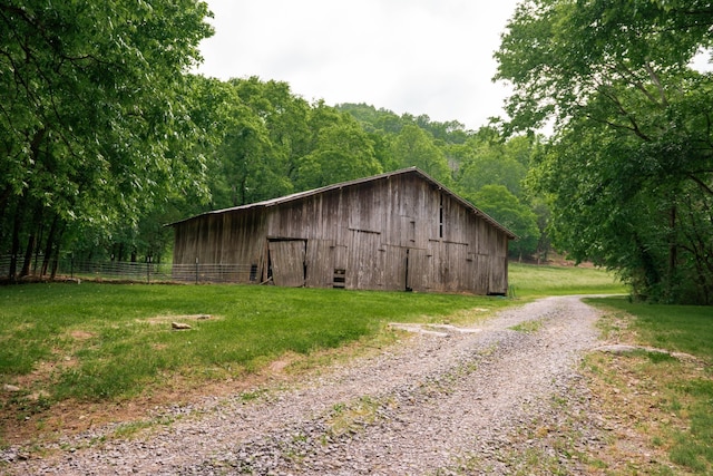 view of outbuilding with a lawn