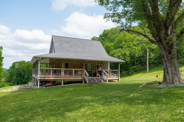 farmhouse inspired home featuring a wooden deck and a front lawn