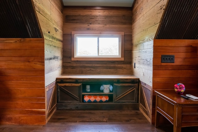 interior space with wooden walls and dark wood-type flooring