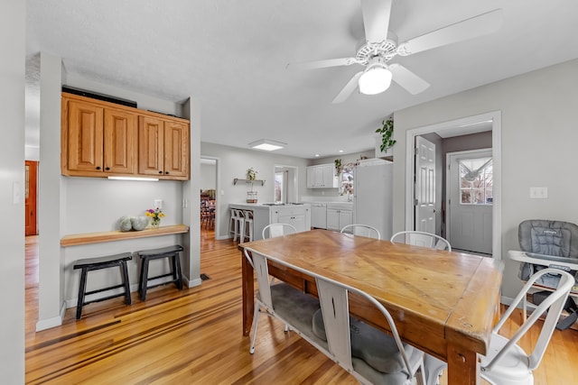 dining room with light wood-type flooring and ceiling fan