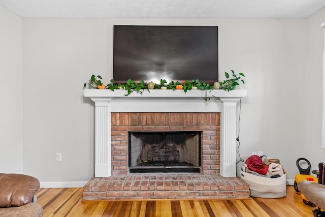 room details with hardwood / wood-style flooring and a brick fireplace