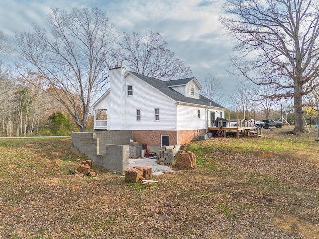 view of home's exterior featuring central air condition unit and a deck