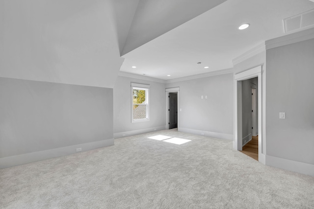 carpeted empty room featuring vaulted ceiling and ornamental molding