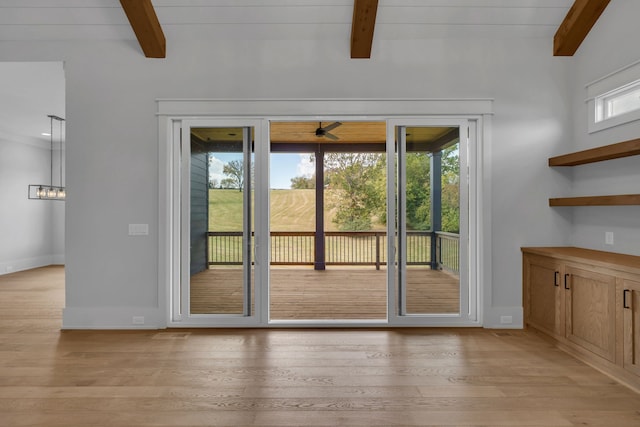 entryway featuring vaulted ceiling with beams, light hardwood / wood-style flooring, and a wealth of natural light